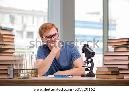 Young student tired and exhausted preparing for chemistry exam