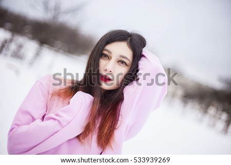 Portrait girl with half red hair in snow. Russian winter asian model.