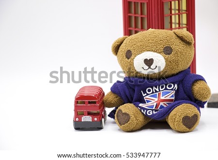 Bear with red double desk London bus are on white background.