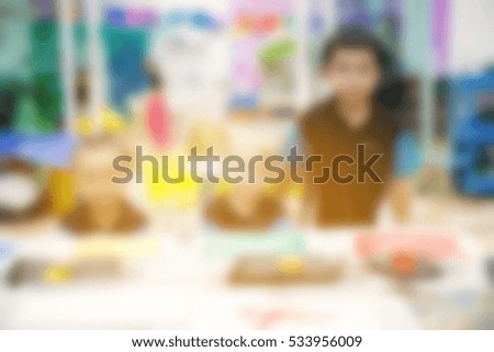 blur background of preschoolers playing and learn in the indoor playground and classroom for background usage with vintage color style.