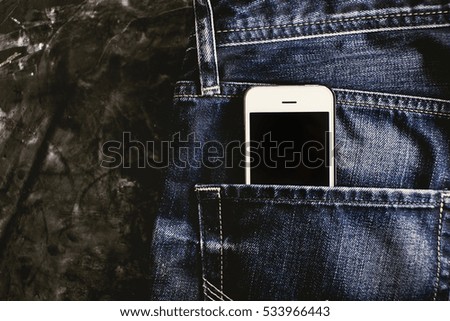 smartphone in the old jeans pocket.