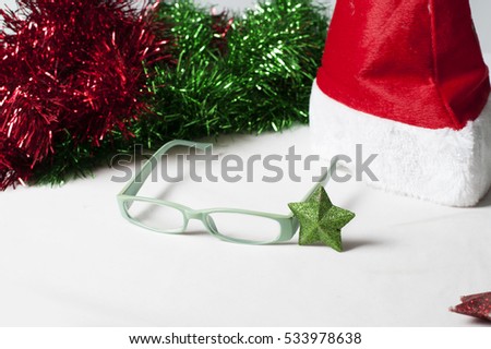 Green glasses as a Christmas present. Decorated with red hat And green star