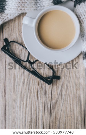coffee cup with glasses on the scarf and Wooden in vintage tone