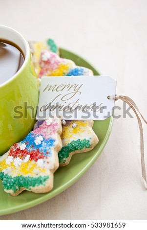 Coffee cup with festive christmas cookies around the cup