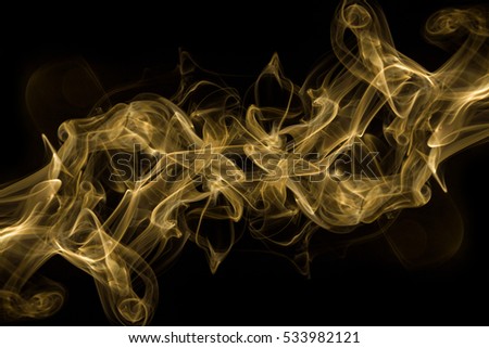 Abstract movement of gold smoke on black background,fire flame