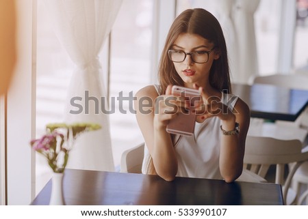 beautiful business lady drinking coffee and uses different gadgets