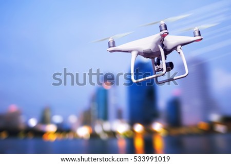 drone photography camera. videography pilot drone . photo city night .quadcopter with high resolution digital technology  camera on the sky .robot drone photography industry ,commercial concept    Royalty-Free Stock Photo #533991019