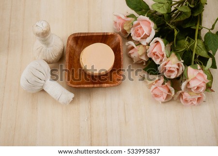 Beautiful spa setting with rose, ,soap , herbal balls,on wooden board