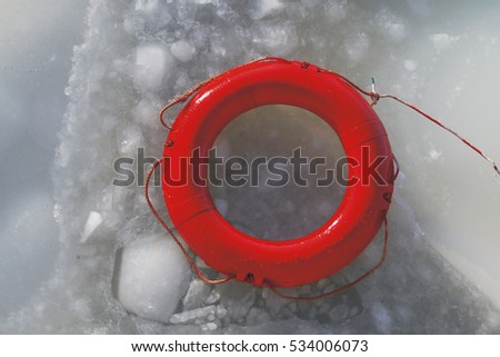 red life buoy on the frozen sea