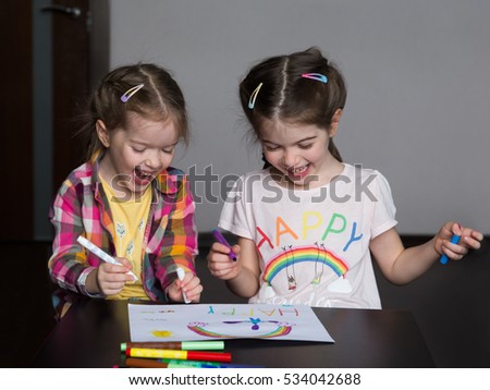 Happy cute kids draw rainbows and write the word  happiness
