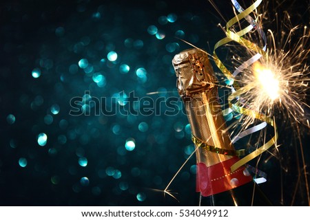 Abstract image of champagne bottle and festive lights. New year and celebration concept
