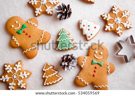beautiful Christmas background with gingerbread men, Christmas trees and snowflakes with pine cones Royalty-Free Stock Photo #534059569