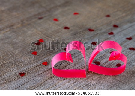 Two paper hearts Valentine, wooden background with heart.
