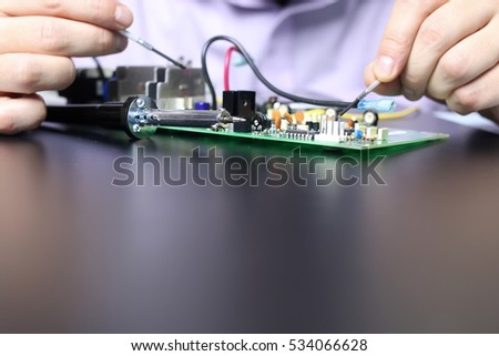 chip soldering man hands and foreground space for text
