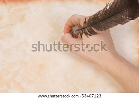 male hand holding the feather
