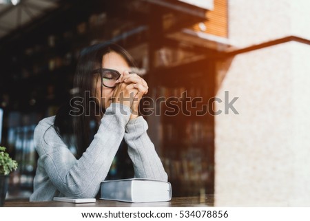 Woman pray with bible, Asian woman  believe in the  prayer to God, Christian student pray for study to pass the exam in the library at the college .Bible and christian study concept Royalty-Free Stock Photo #534078856
