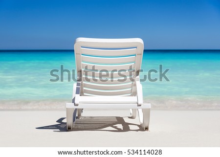 Sunbeds on tropical sandy beach. Vacation on the sea
 Royalty-Free Stock Photo #534114028
