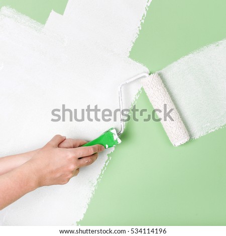 Closeup of a hand with paint roller