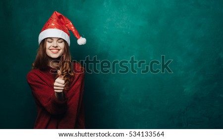 Cheerful woman in bright green New Year's background shows a sign of class