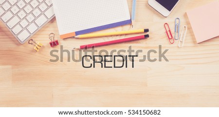 Business Workplace with  CREDIT Concept on Wooden Background