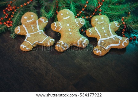 Christmas homemade gingerbread cookies on wooden table. Spruce