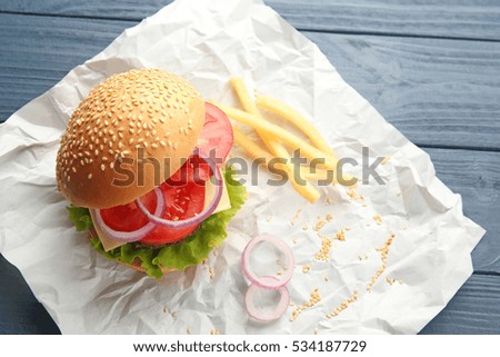 Delicious cheeseburger on paper background