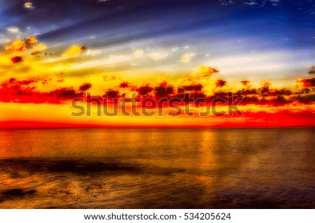 Gold red glorious epic South African idyllic scenic sunset on the coast over the sea near Cape Town South Africa, sun rays, water cloud reflection,sea,peaceful,harmony,calm,quiet,intense glowing color