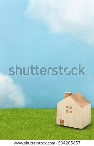 House on green grass over blue sky. Mortgage concept.