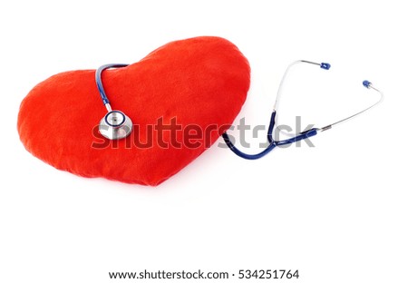 Close up view of blue stethoscope with toy plush heart over isolated white background