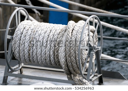 The big reel for rolls long rope on the ship 