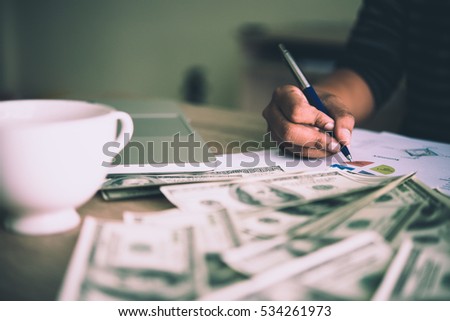 Working place of trader. The table covered by cash notes, financial charts. Business financial working.