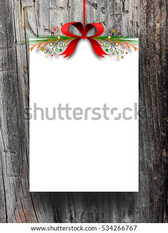Blank frame hanged by red Christmas ribbon against dark wooden background