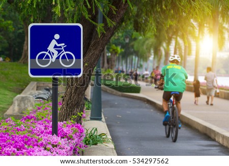 Bike lane and bike sign in middle of park in Bangkok. Cyclists always spend their time on bicycles. They ride it for exercise and relaxiation.