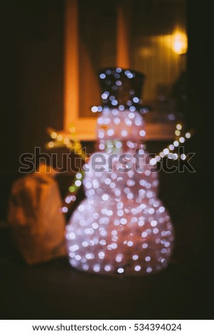 snowman with a bag made of multicolored garlands