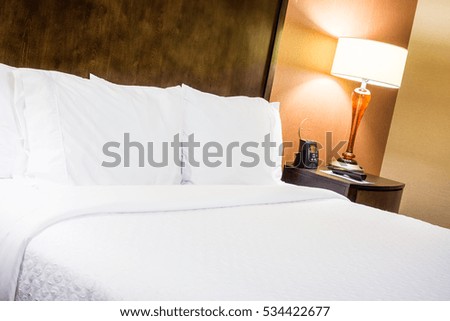Hotel Room Bed with a Lamp on a Nightstand