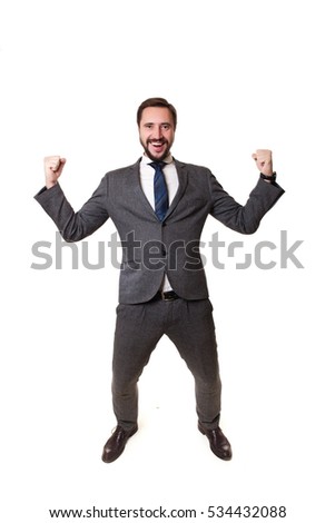 Business man throwing fists in air and smiling while celebrating