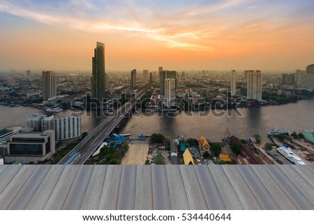 Opening wooden floor, Aerial view Bangkok city downtown with river curved and beauty sunset background