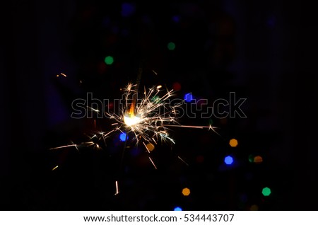 Sparkler on bokeh background. Christmas sparkler.