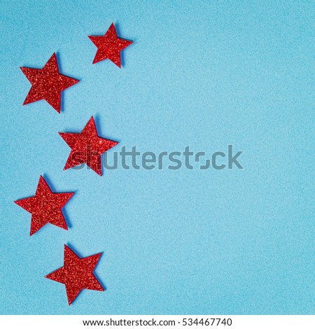 Red shining stars on the left side of a light blue textured background