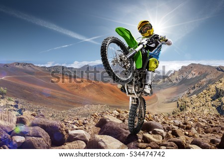 Professional dirt bike rider doing wheely Royalty-Free Stock Photo #534474742