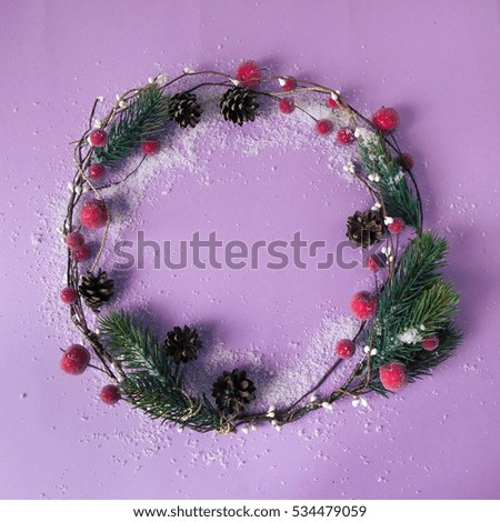 Handmade christmas wreath with copy space for text on purple color background. Top view