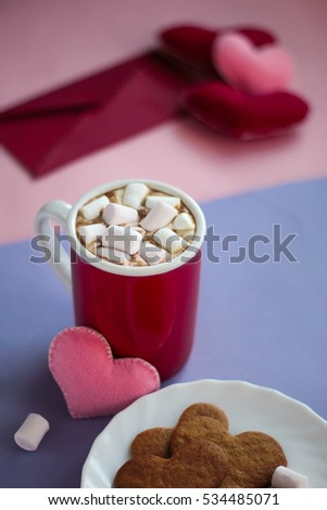 Still life gingerbread cookies, cup of cocoa with marshmallows and felted hearts on dark wooden background Valentines day Celebration top view