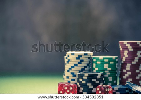roulette chips and dices on green poker table