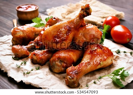 Baked chicken drumstick on paper, close up view Royalty-Free Stock Photo #534547093