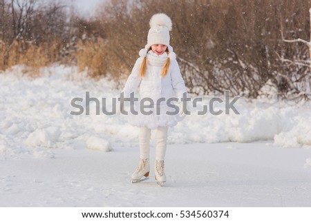 Pretty Girl skating in winter sunny snow day