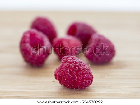 Ripe sweet raspberries on wooden table. Close up, high resolution product
