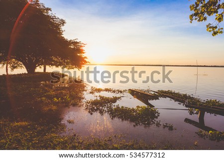 Sunset with tree  reflection in a lake at Ubonrat dam, Khon Khan city, Thailand.