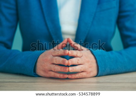 Businesswoman body language for confidence and self-esteem, hands with steepled fingers on office desk Royalty-Free Stock Photo #534578899