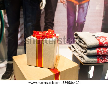 Big christmas boxes and sweaters in the mall interior. Concept of sale and gifts