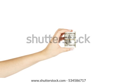 Isolated female hand with twisted stack of dollars on white background.